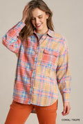 Woman wearing coral and taupe plaid flannel shirt with chest pocket and orange pants